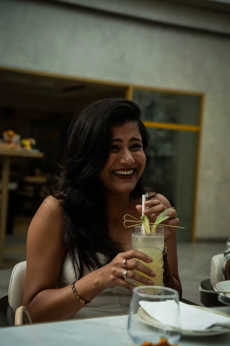 A guest smiling over a drink